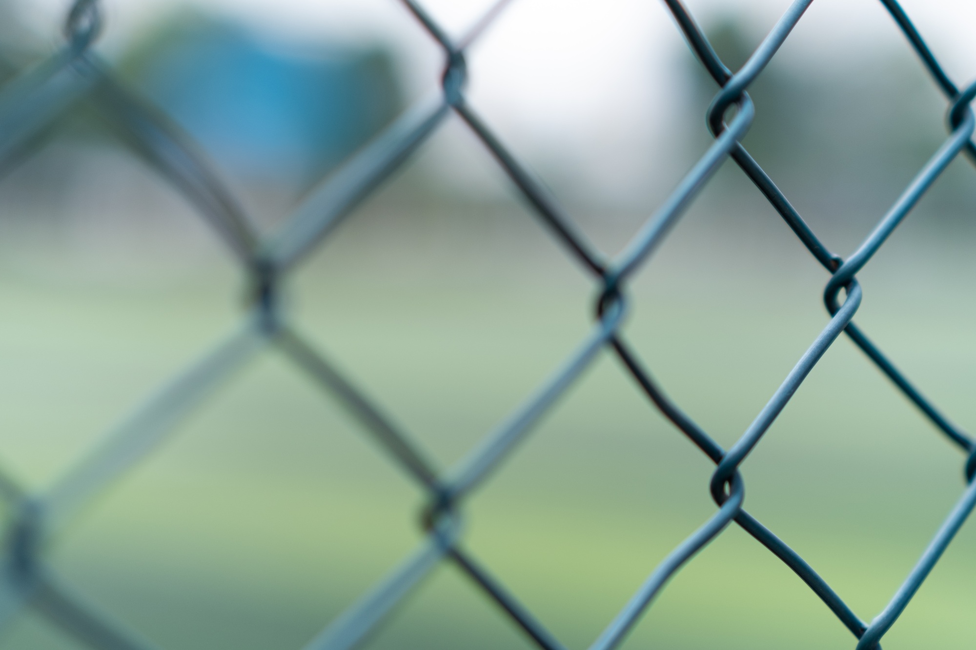 Cells of braided metal fence installed on border of private property preventing unwanted penetration