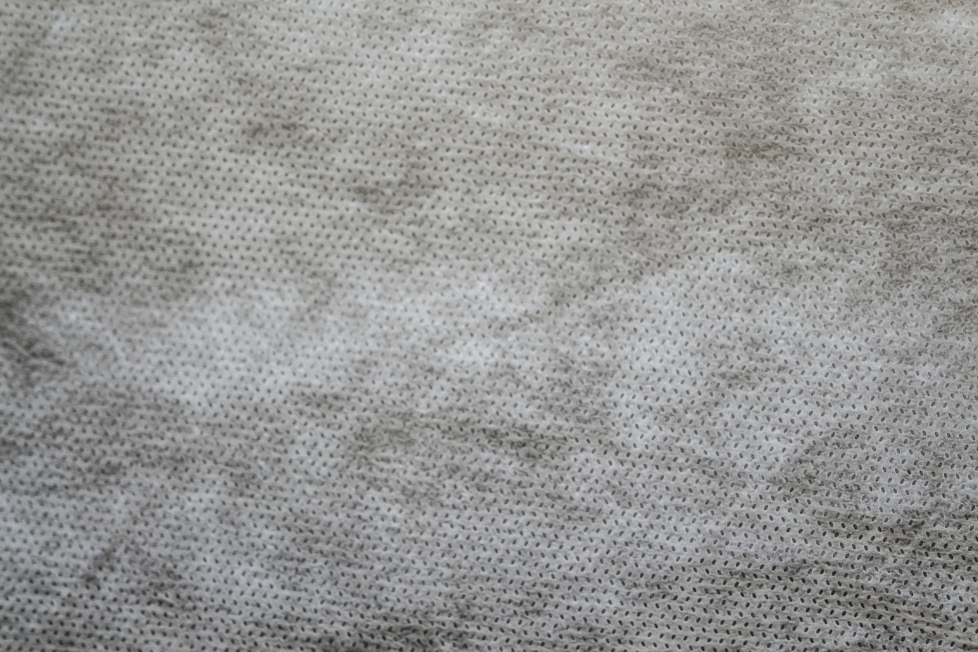 grey spunbond non-woven geotextile close-up macro. Small spots. Dirtied texture. Design, background,